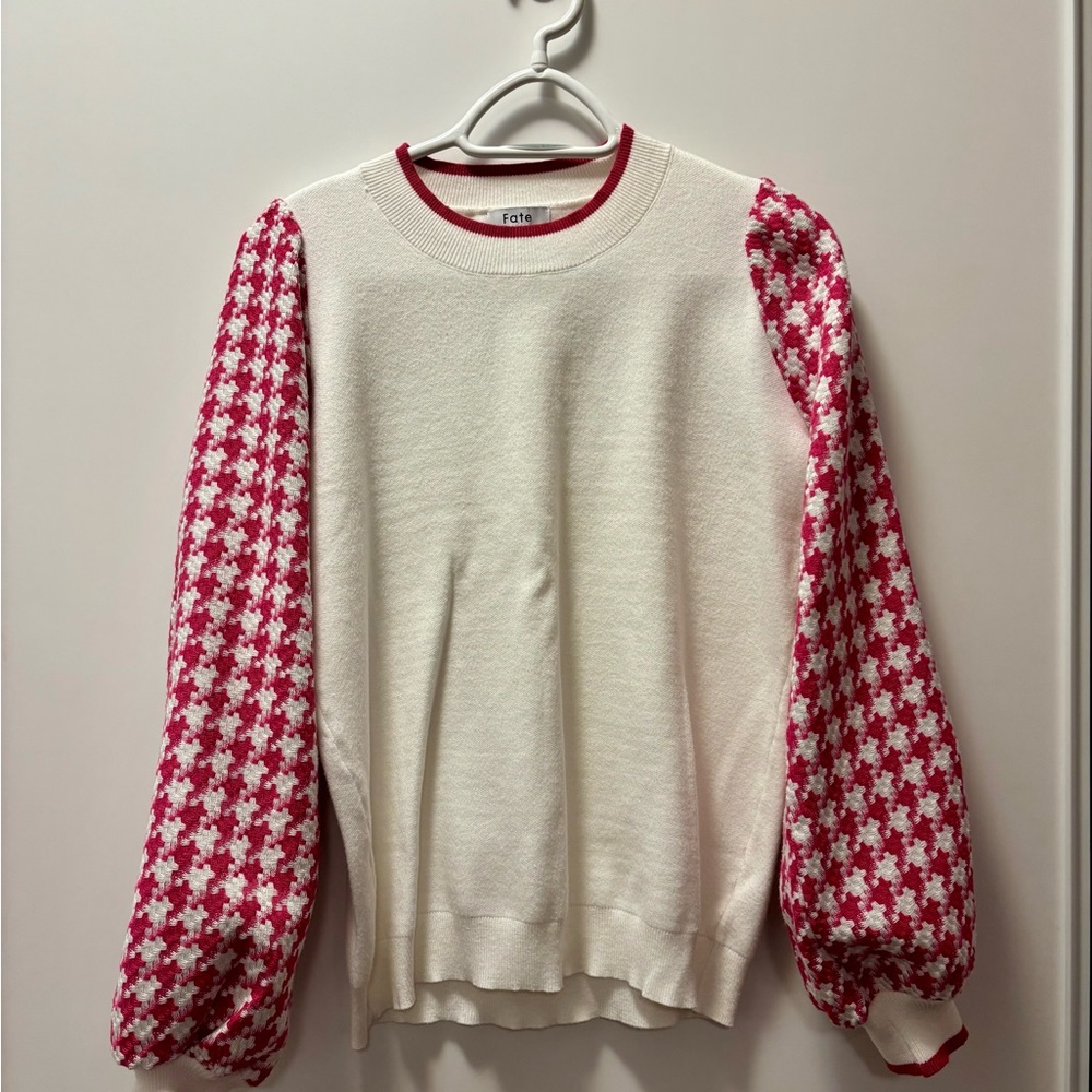 White sweater with pink houndstooth sleeves